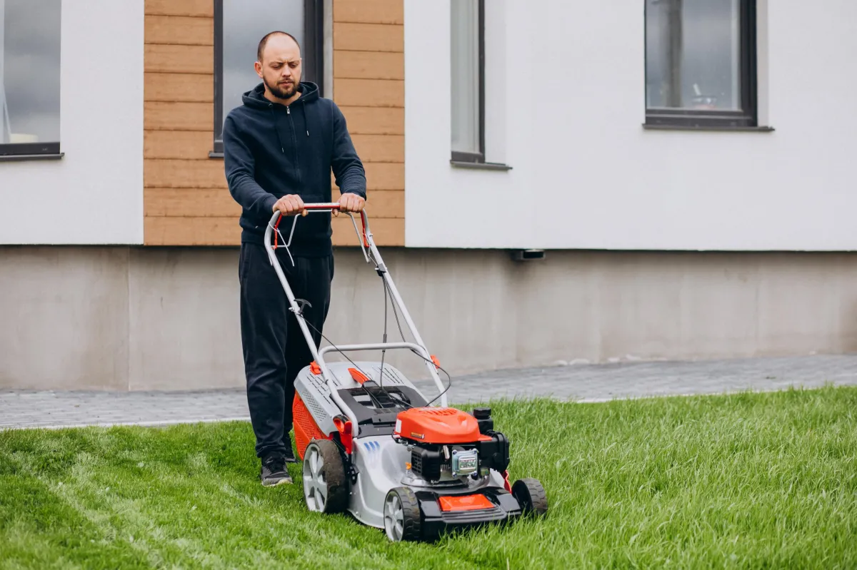 Professional mowing a green lawn