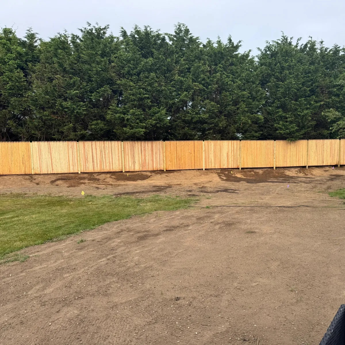 Long newly installed cedar privacy fence
