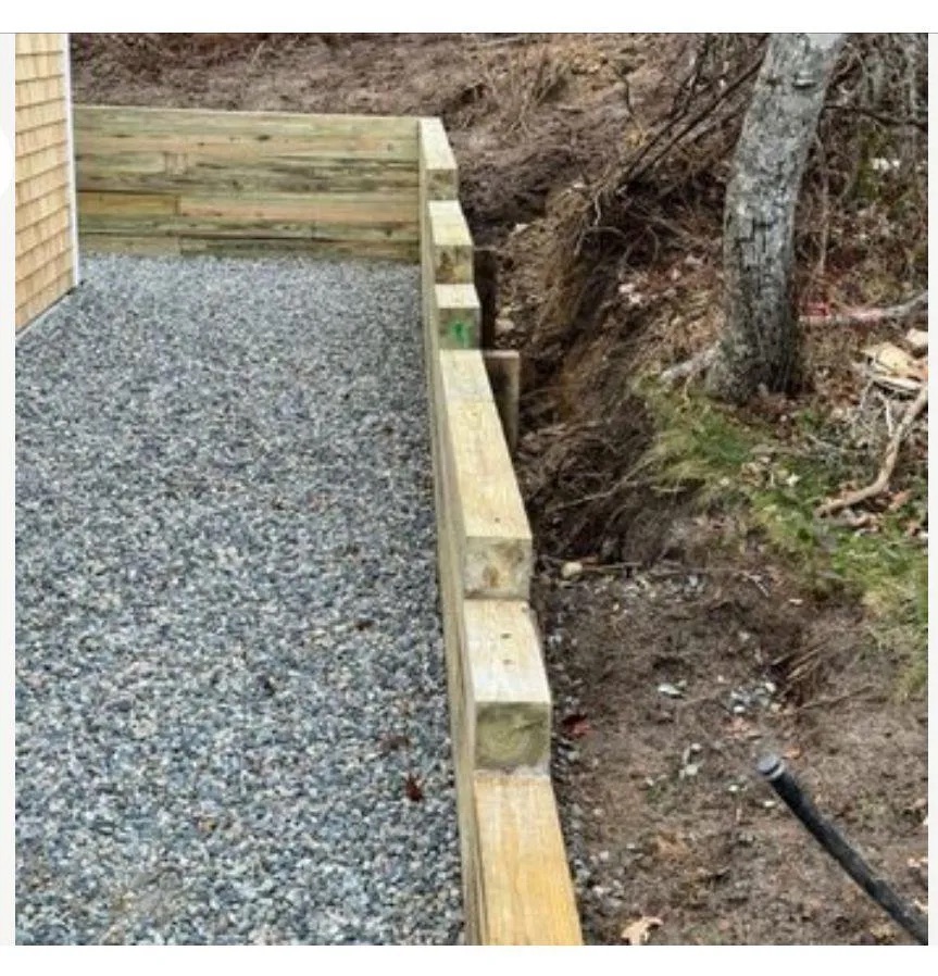 Gravel terrace and timber retaining wall